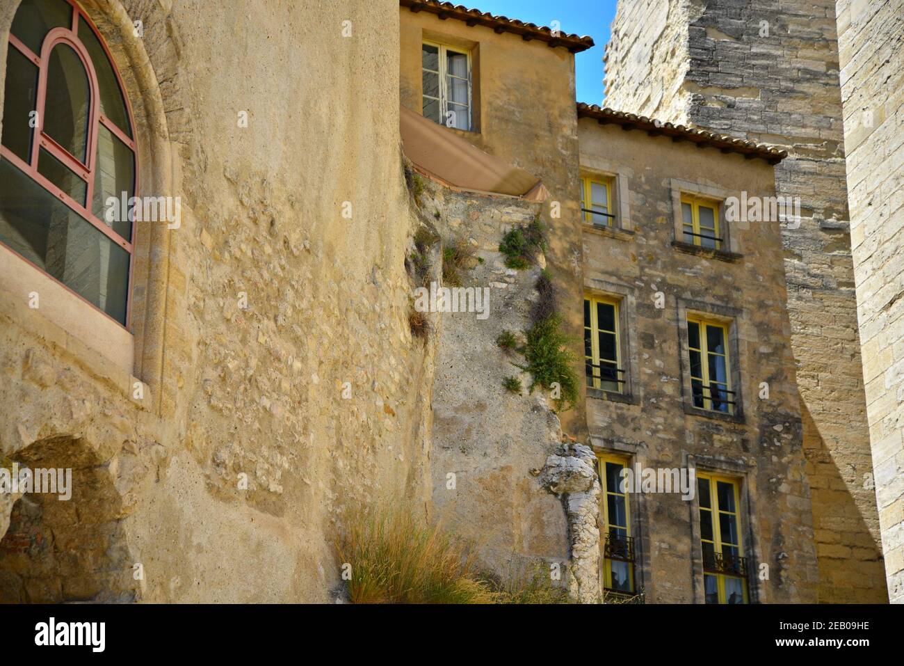 Facade view of ancient historic stone buildings in Avignon Old Town ...
