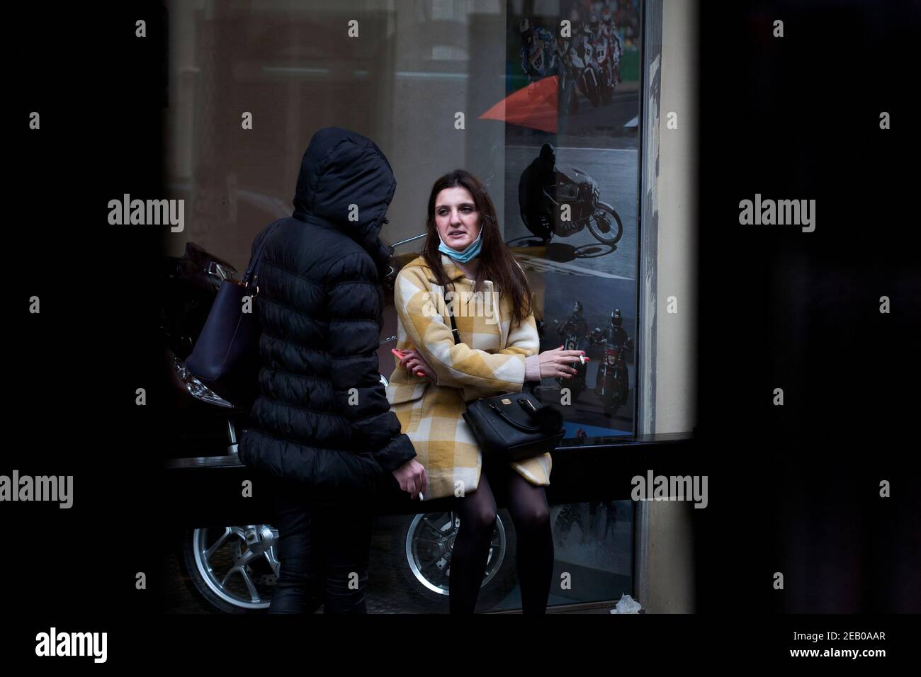 Two women smoking a cigarette in the street, Barcelona, Spain. Stock Photo