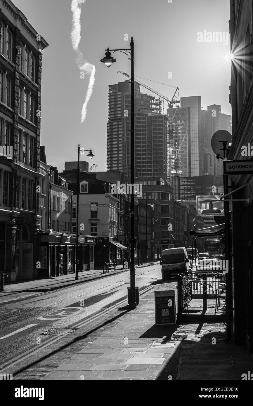 Harsh winter sunlight creates bright light and deep shadows in a city street, Curtain Road, London Stock Photo