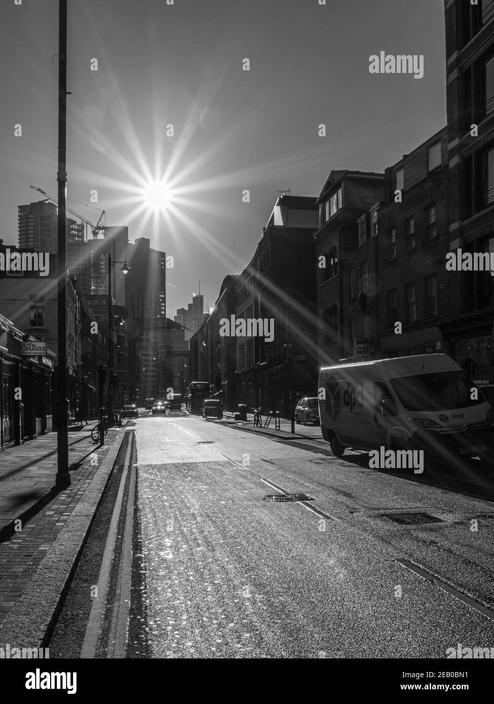 Harsh winter sunlight creates bright light and deep shadows in a city street, Curtain Road, London Stock Photo