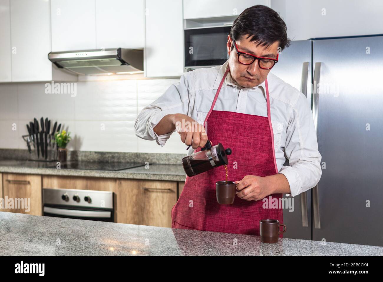 https://c8.alamy.com/comp/2EB0CK4/latin-man-serving-coffee-from-a-french-press-to-a-cup-in-the-kitchen-of-his-home-or-in-a-restaurant-2EB0CK4.jpg