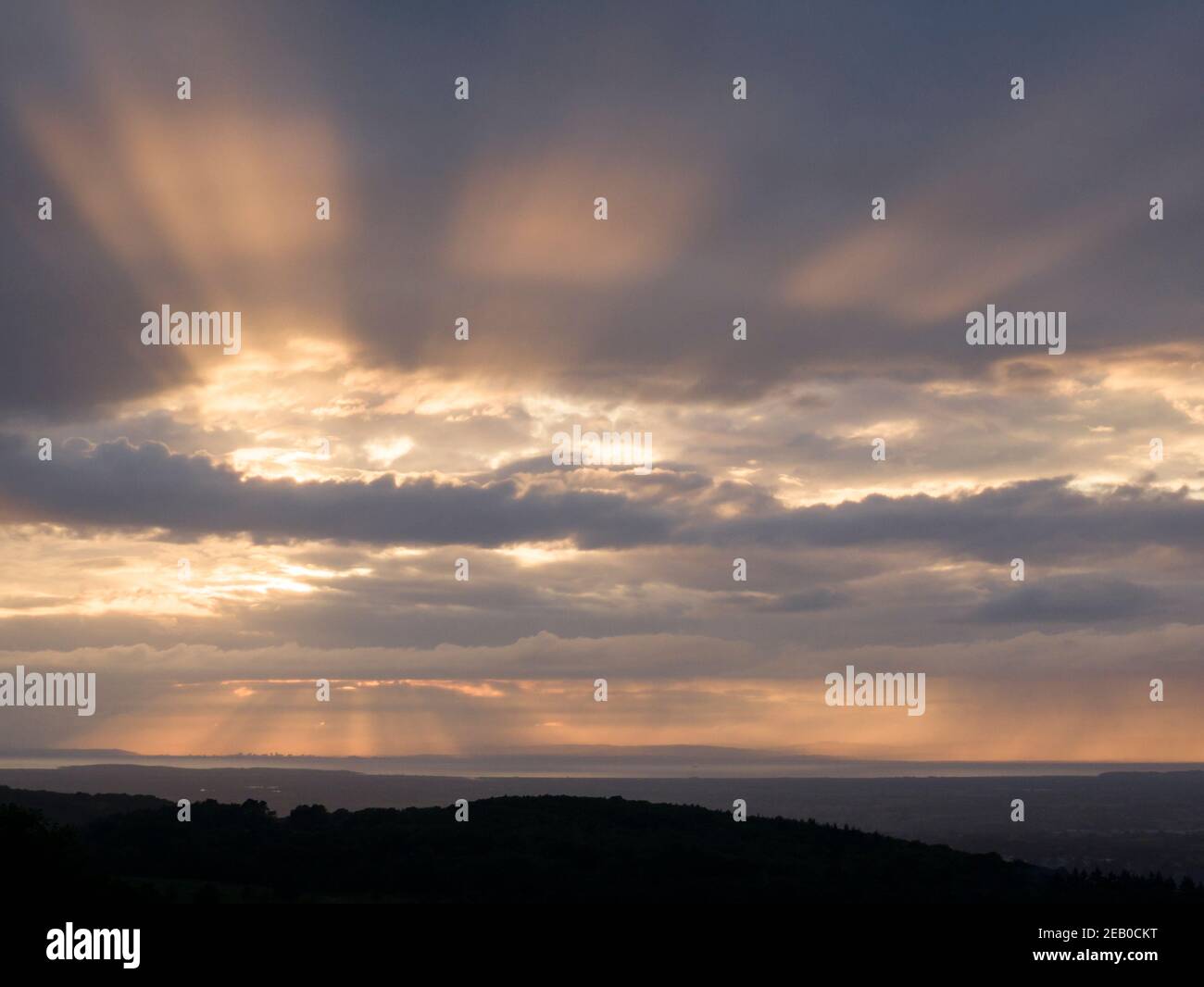 Crepuscular Rays over the Bristol Channel viewed from Black Down in the Mendip Hills, Somerset, England. Stock Photo