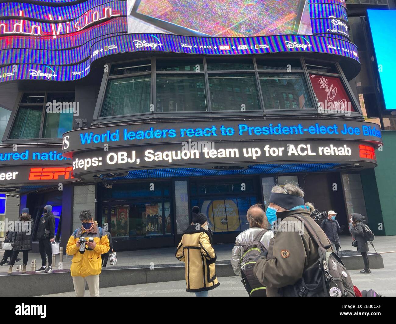 Visitors to Times Square in New York watch the WABC news ticker during the inauguration of 46th President Joseph Biden and Vice-President Kamala Harris on Wednesday, January 20, 2021. (© Frances M. Roberts) Stock Photo