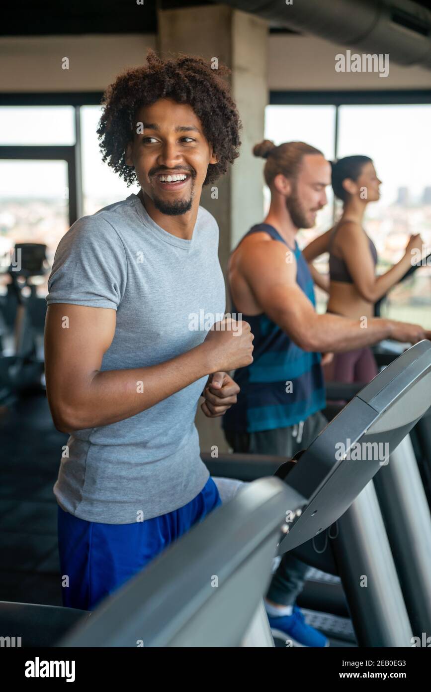 Group of young people running on treadmills in sport gym Stock Photo ...