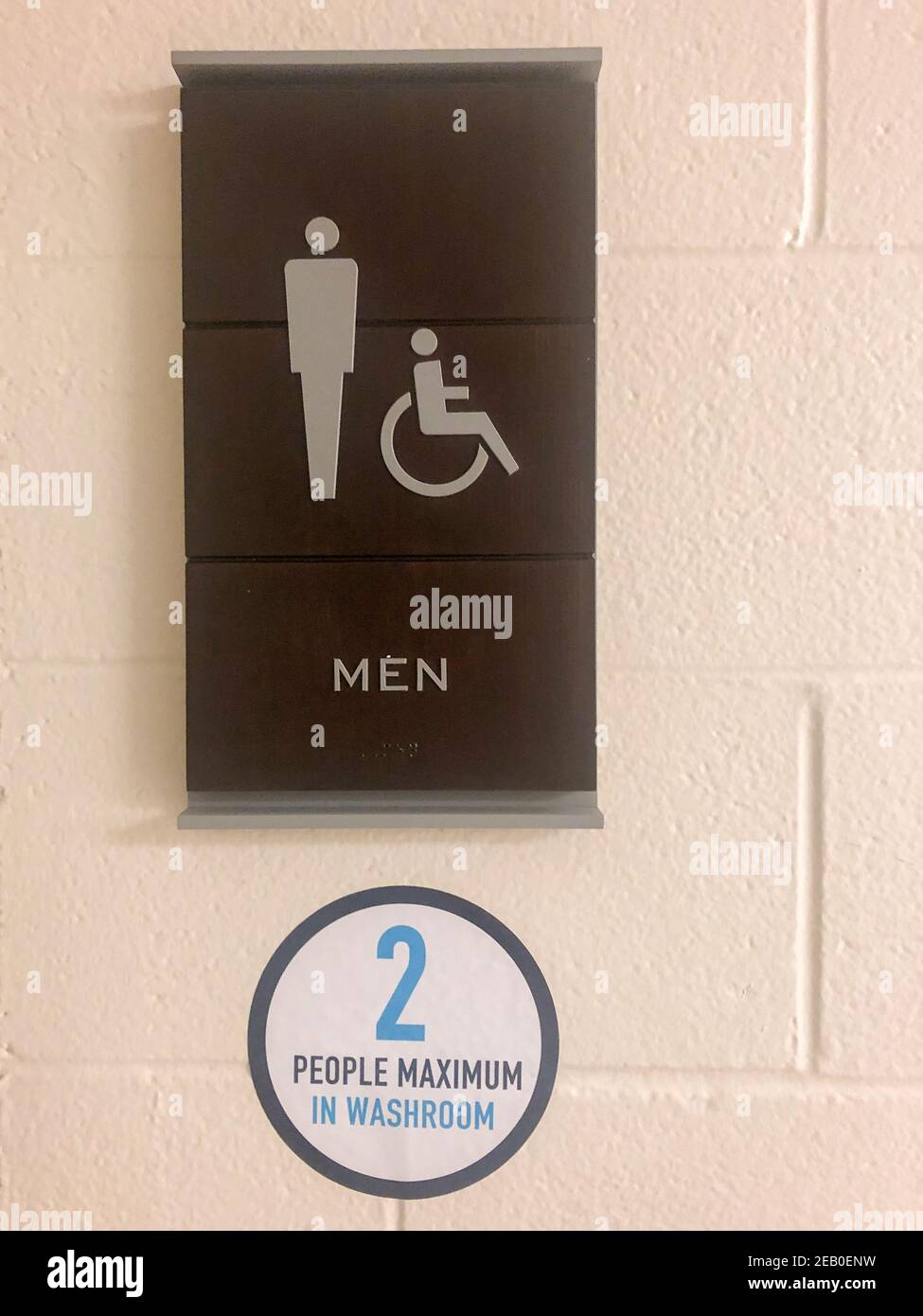 Sign regarding social distancing rules in public bathroom. Stock Photo