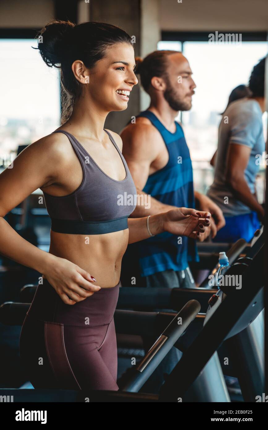 Group of young people running on treadmills in sport gym Stock Photo ...