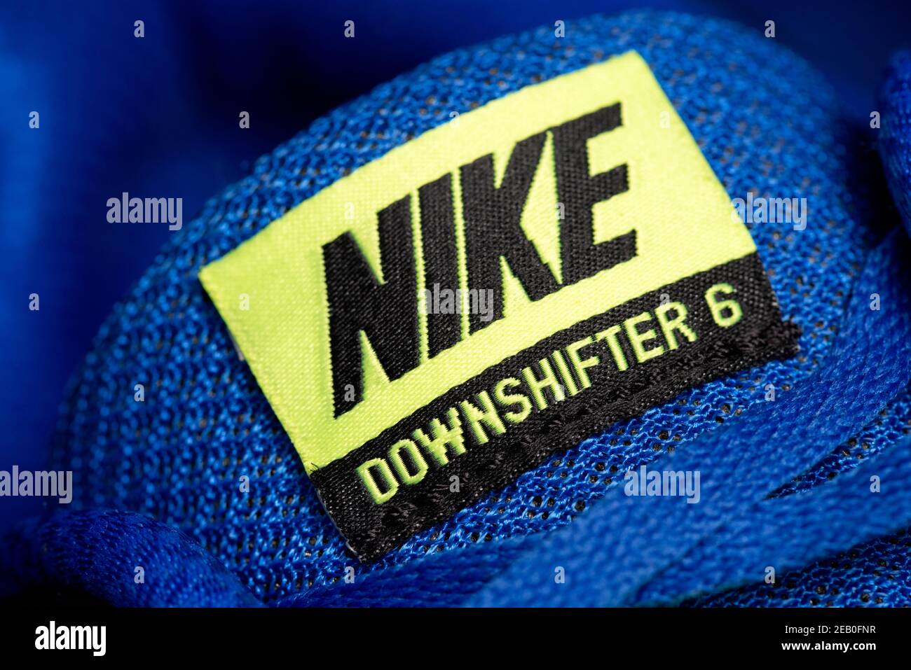 Nike Downshifter 6 yellow logo and label on blue trainers tongue Stock  Photo - Alamy