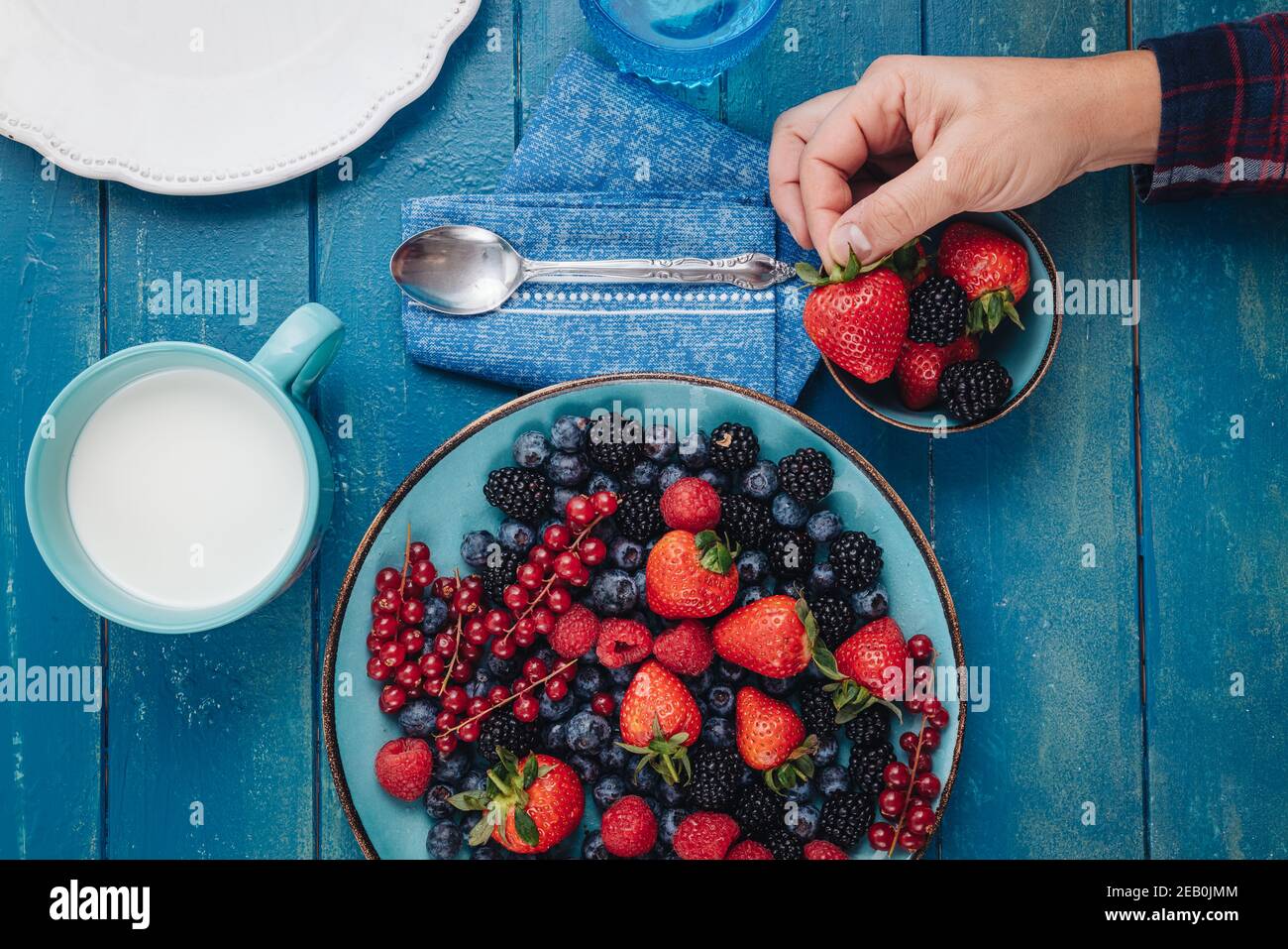 Healthy breakfast eating a mix of raw fresh berries fruits Stock Photo
