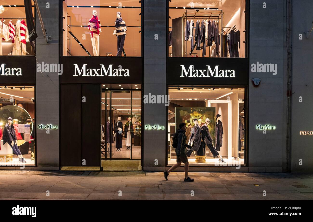 A man walking past the Max Mara in New Bond Street in London, during the  third nationwide lockdown.Max Mara is a up-market ready-to-wear Italian  fashion company. It was established in 1951 in