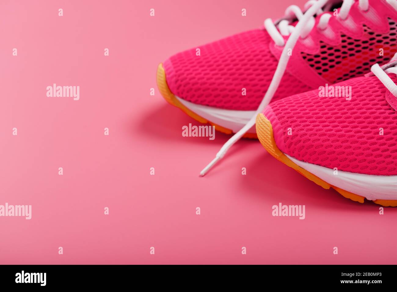 Sports pink sneakers on a pink background with free space. Top view ...