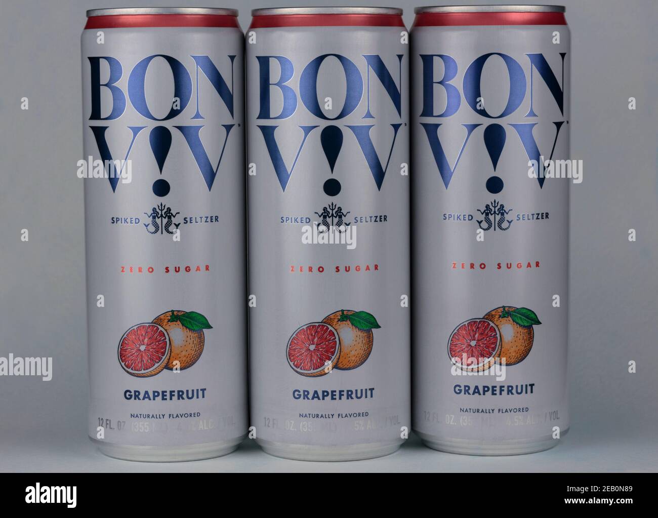 group of three cans of Bon Viv brand spiked seltzer, hard seltzer water with alcohol added, a popular beverage, on a pale blue background Stock Photo