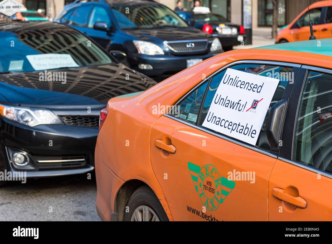 Toronto taxi drivers protest against the operation of UberX who was deemed illegal by the city until new regulation bylaws are approved. UberX is givi Stock Photo