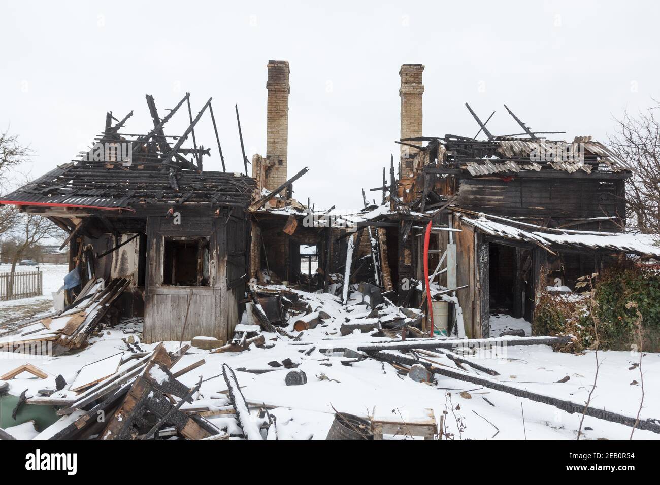 Burnt wooden house. House after the fire. Burned brick house with burnt roof inside view Stock
