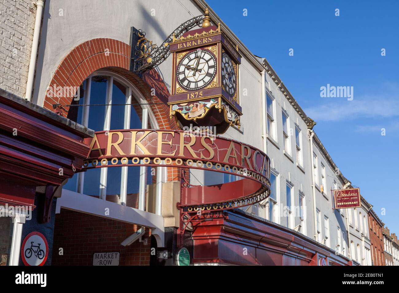 The ornate golden clock and sign marking the entrance to Barkers Arcade on Northallerton High Street Stock Photo