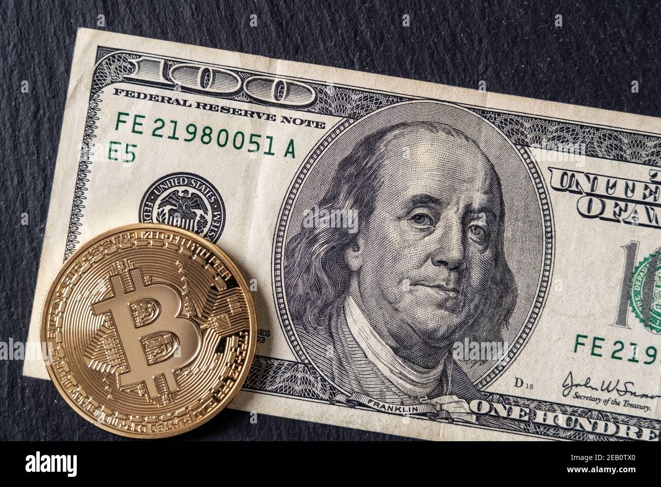 Bitcoin cryptocurrency equivalent to dollar, a banknote of one hundred  units. Future virtual currency concept. On a background of marble, close-up  Stock Photo - Alamy