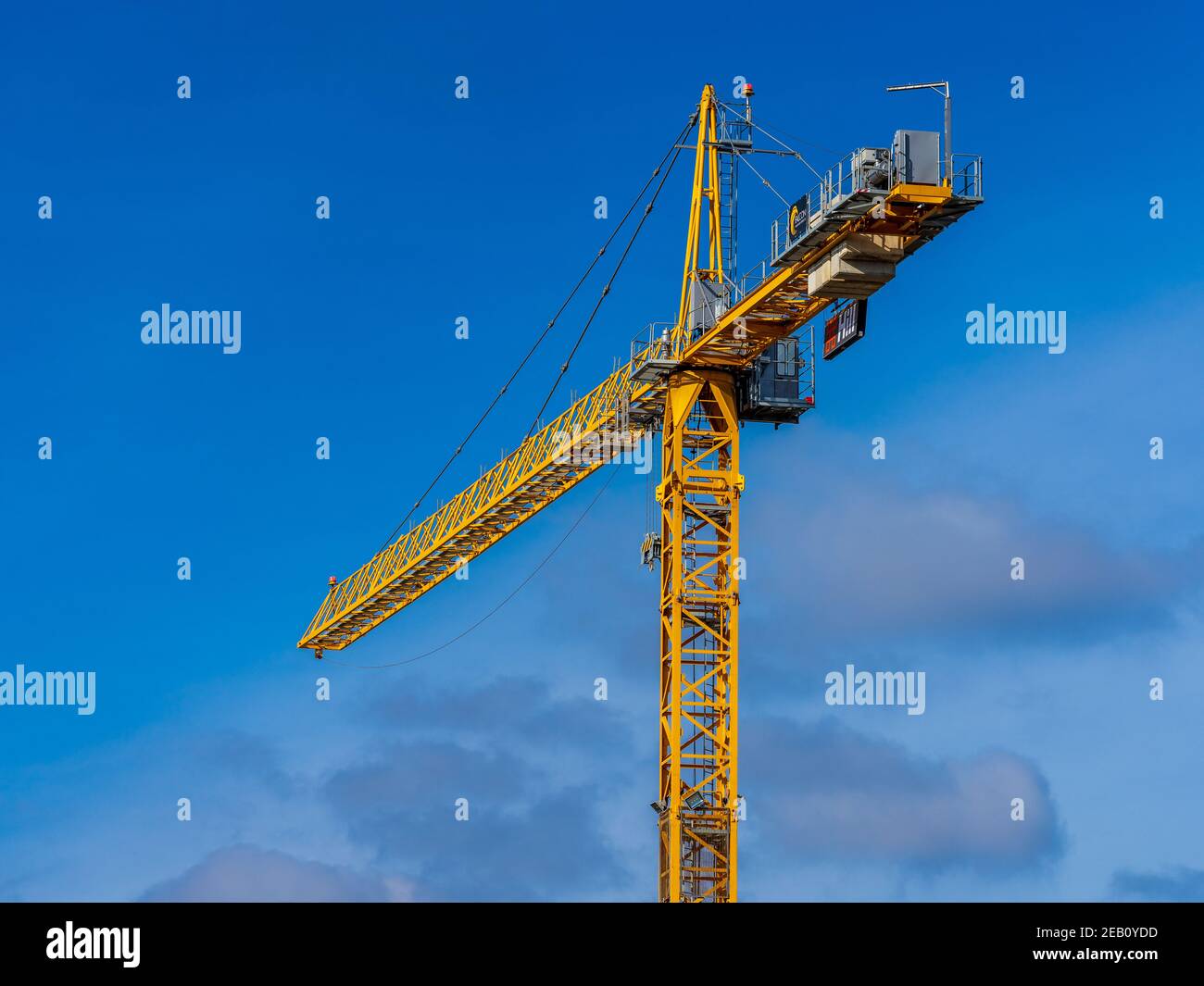 Yellow Crane - Yellow Tower Crane at a Hill development Cambridge from Falcon Tower Crane Services. Falcon are the UK’s largest tower crane supplier. Stock Photo