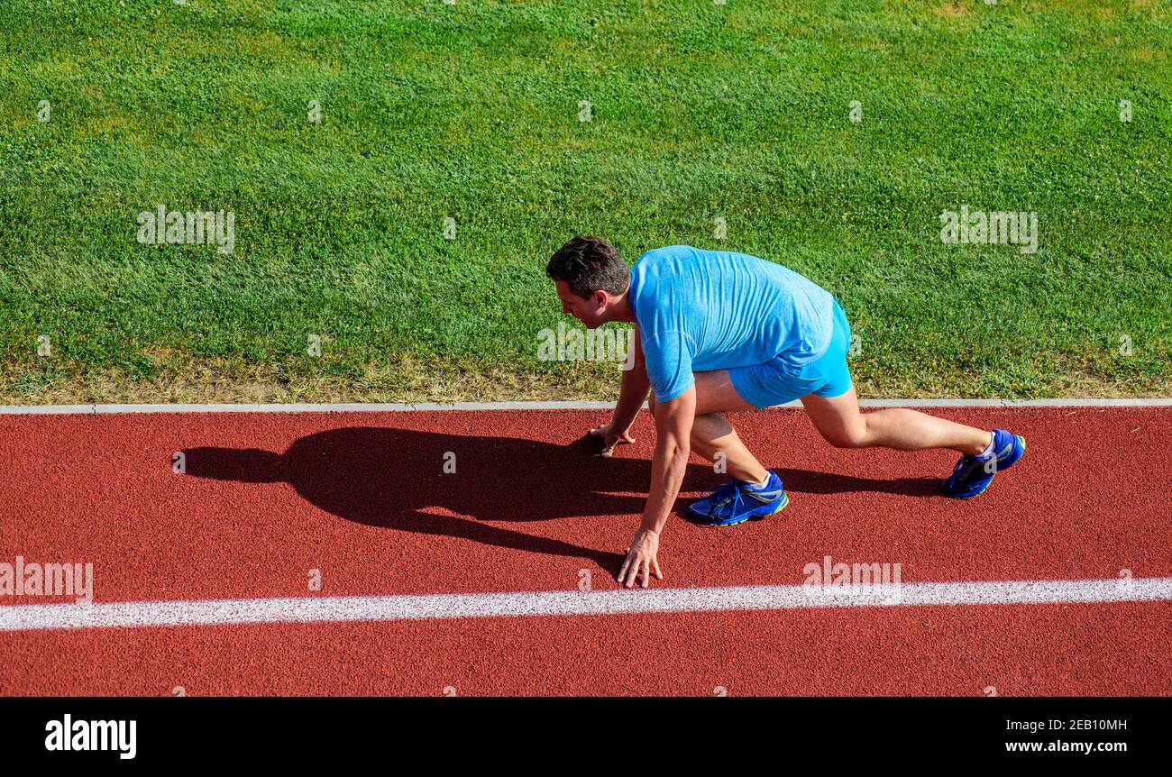 Running tips for beginners. Man athlete stand low start position