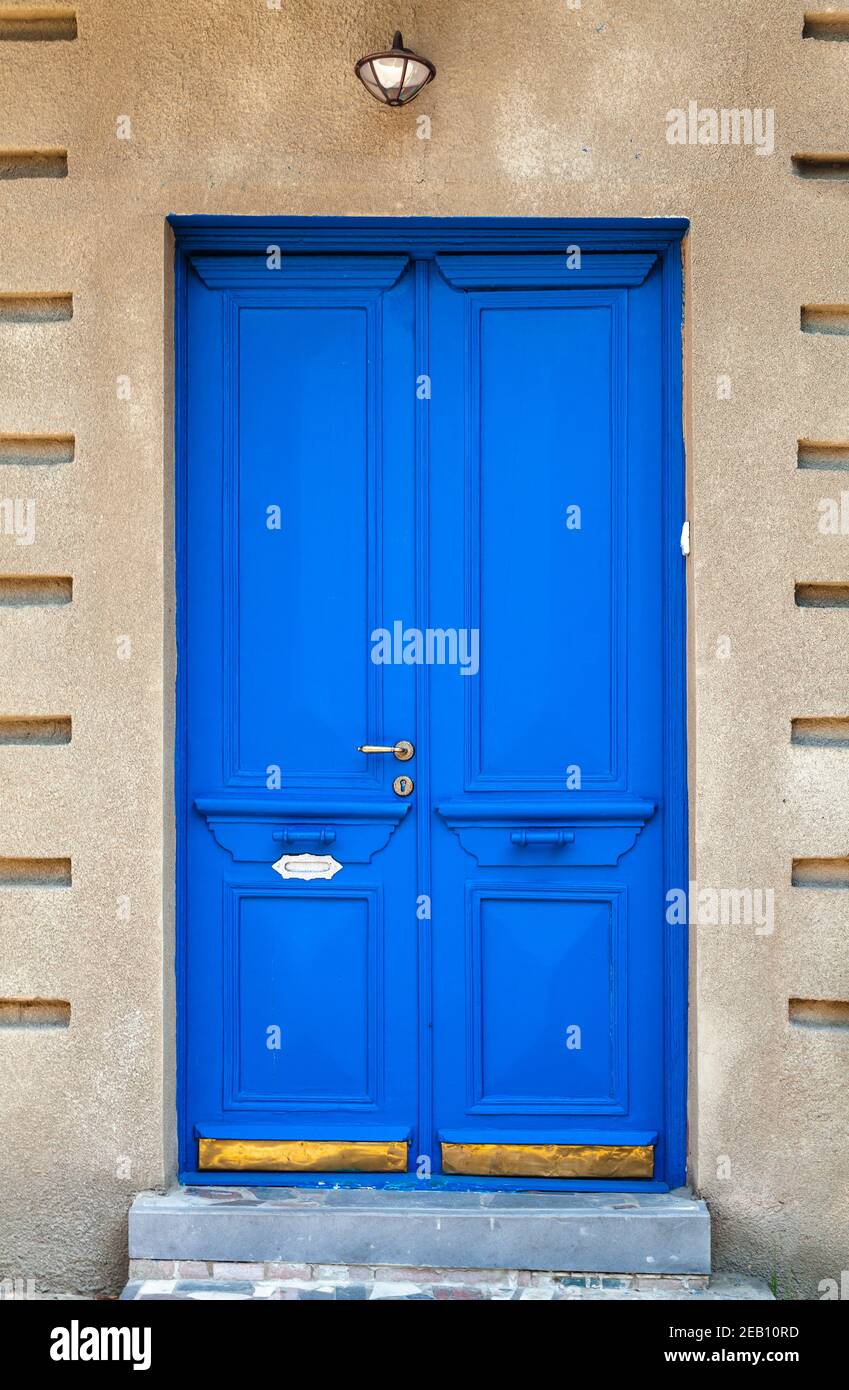 Vintage blue wooden door in a stone wall. Old Tbilisi architecture ...