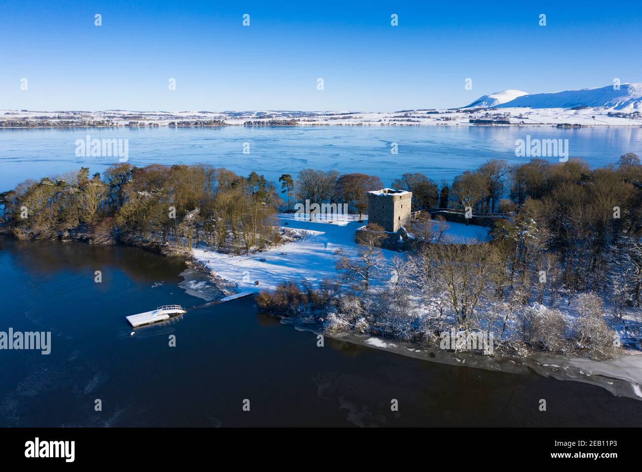 Kinross, Scotland, UK. Aerial view of a snow covered Lochleven Castle situated on small island on Loch Leven, Kinross-shire. Stock Photo