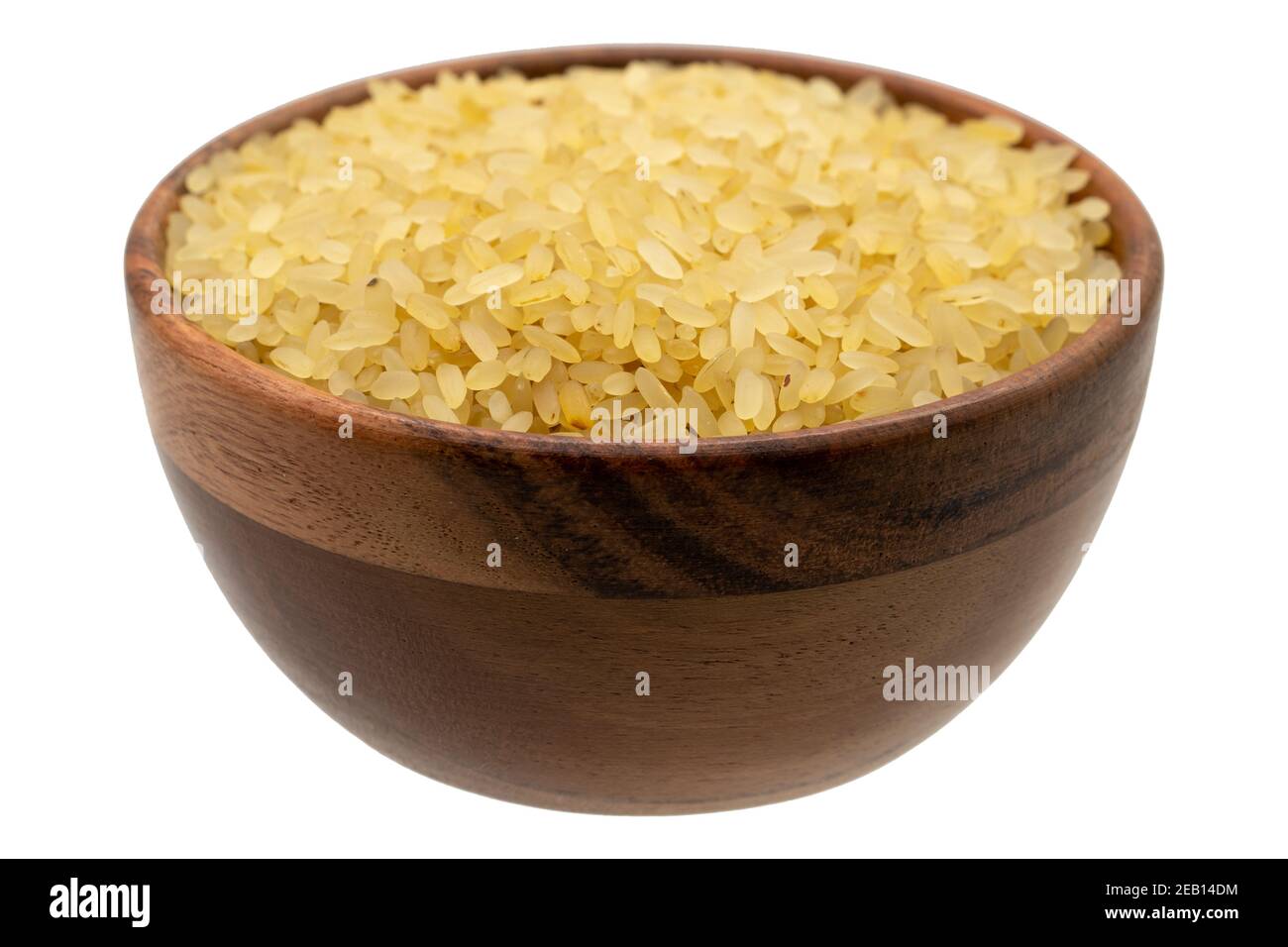 Rice seeds in wood bowl isolated on white background. Close up, top view Stock Photo
