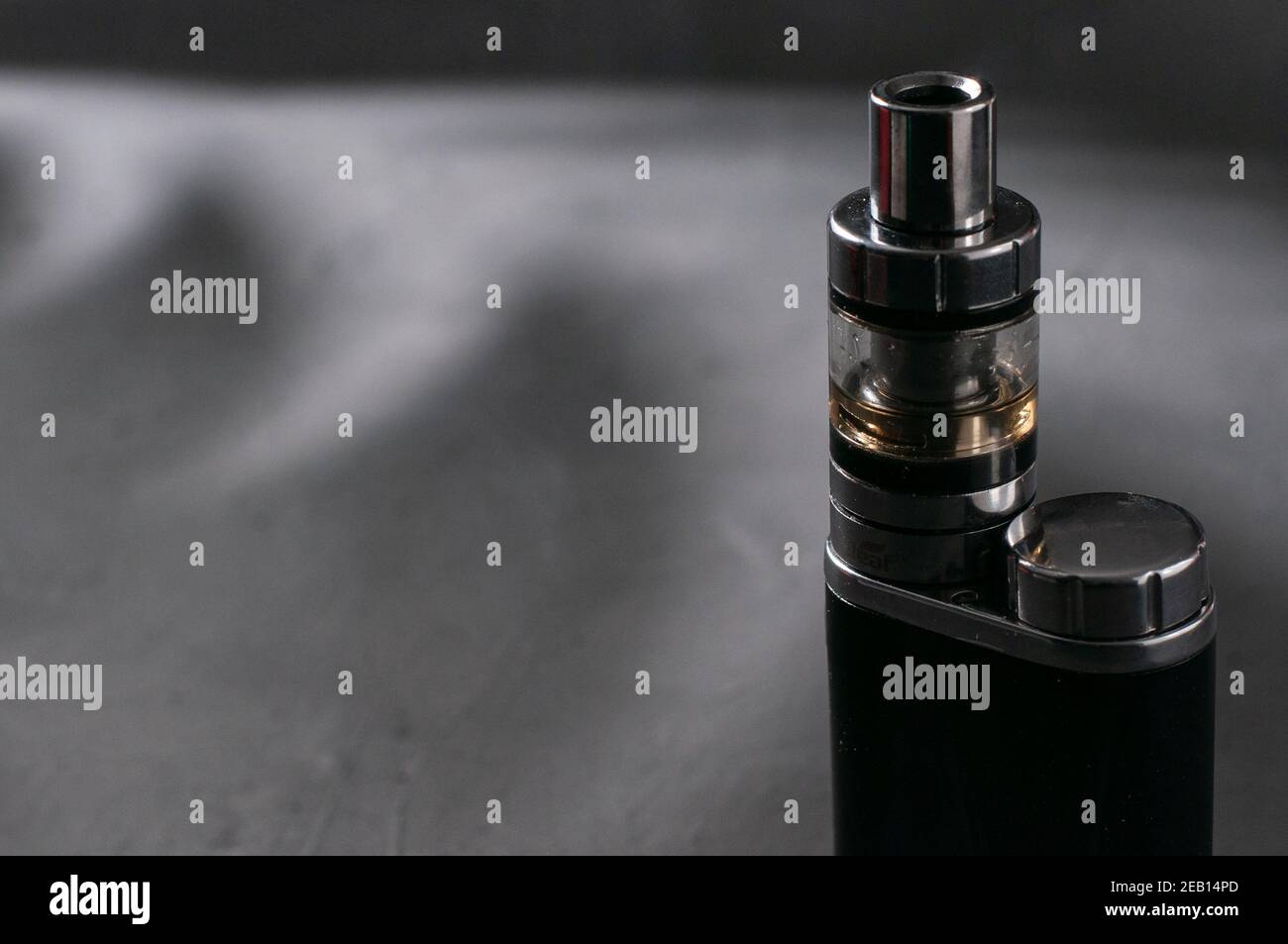 Refillable vape pod in the blurred background with a copy space Stock Photo  - Alamy