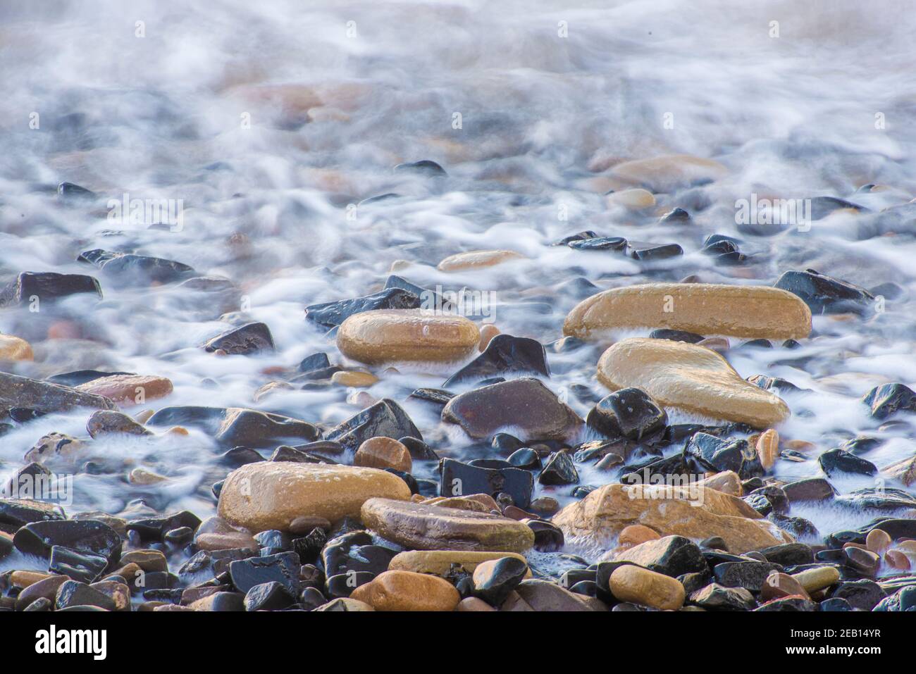 Long exposure of water on rocks Stock Photo - Alamy