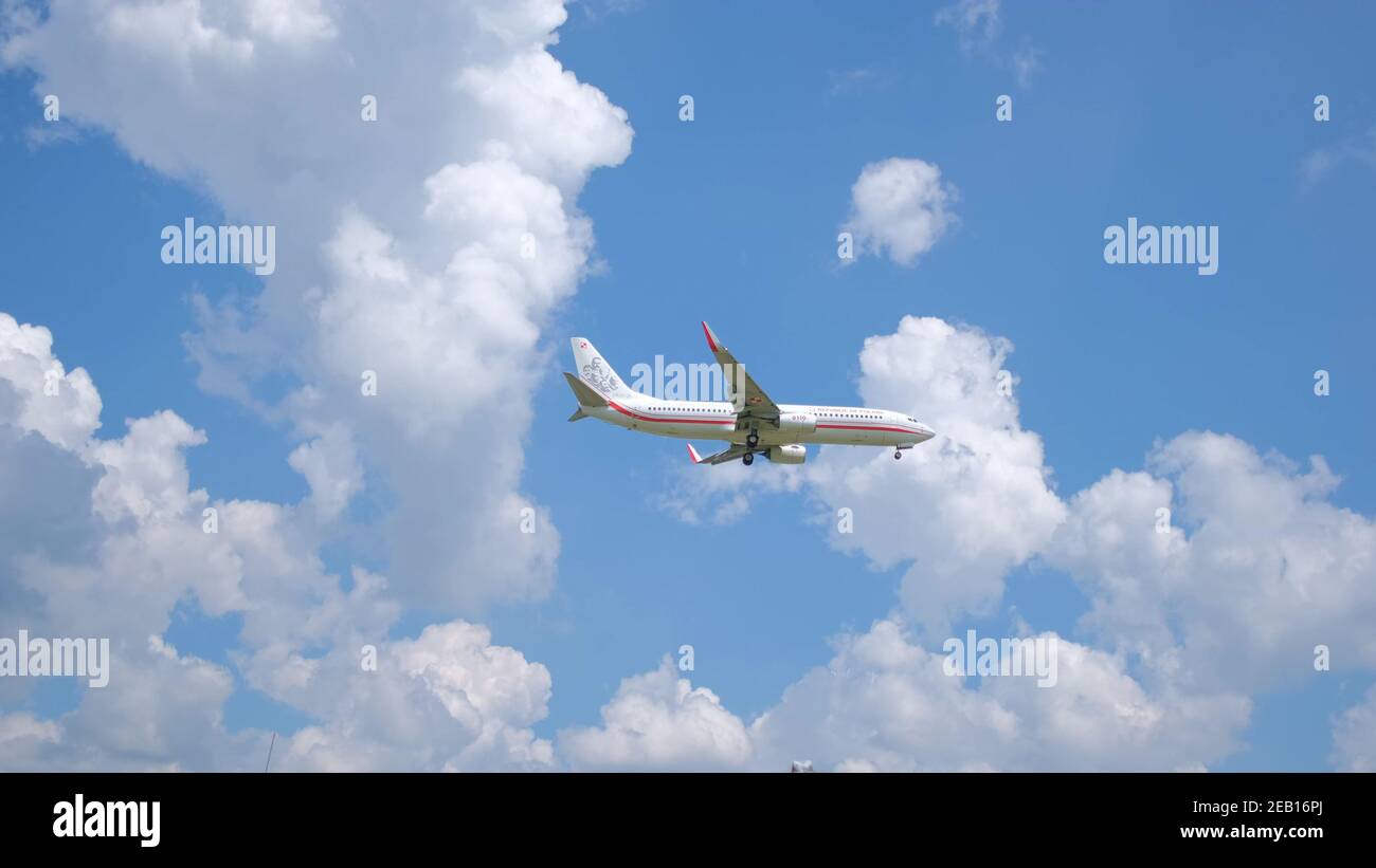 Passenger plane flying in the blue sky. A mixture of clouds and blue ...