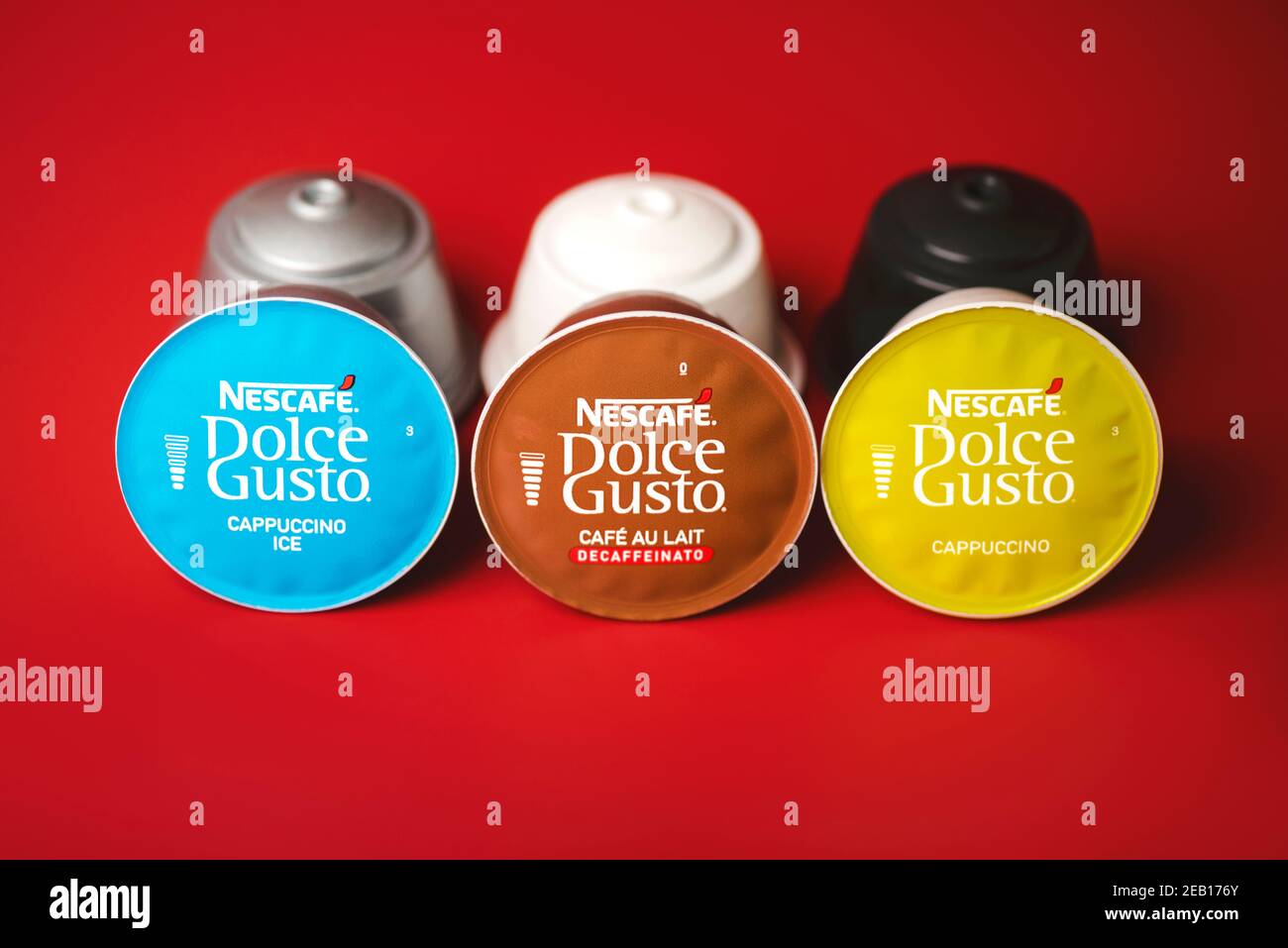 closeup of Nescafe Dolce Gusto capsules,cappuccino ice,cafe au lait,cappuccino on red background.Selective focus Stock Photo