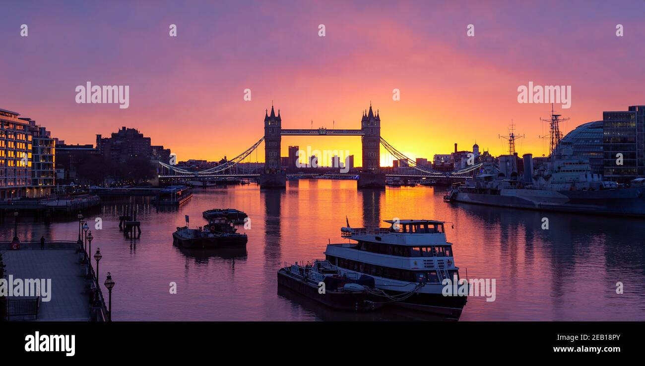 Tower Bridge and River Thames with fiery sky at sunrise Stock Photo