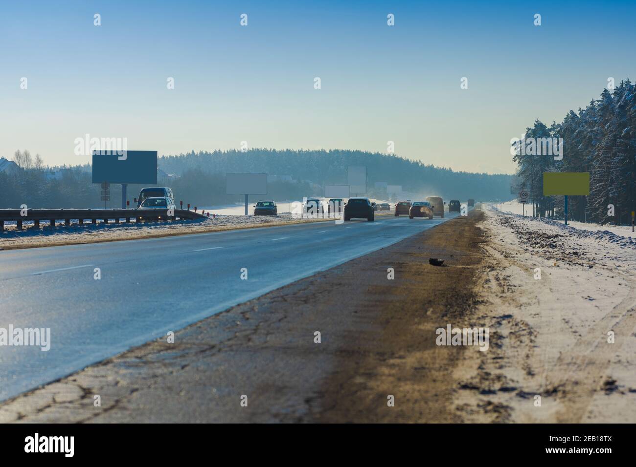 Winter road with snow, highway with cars at sunset Stock Photo - Alamy