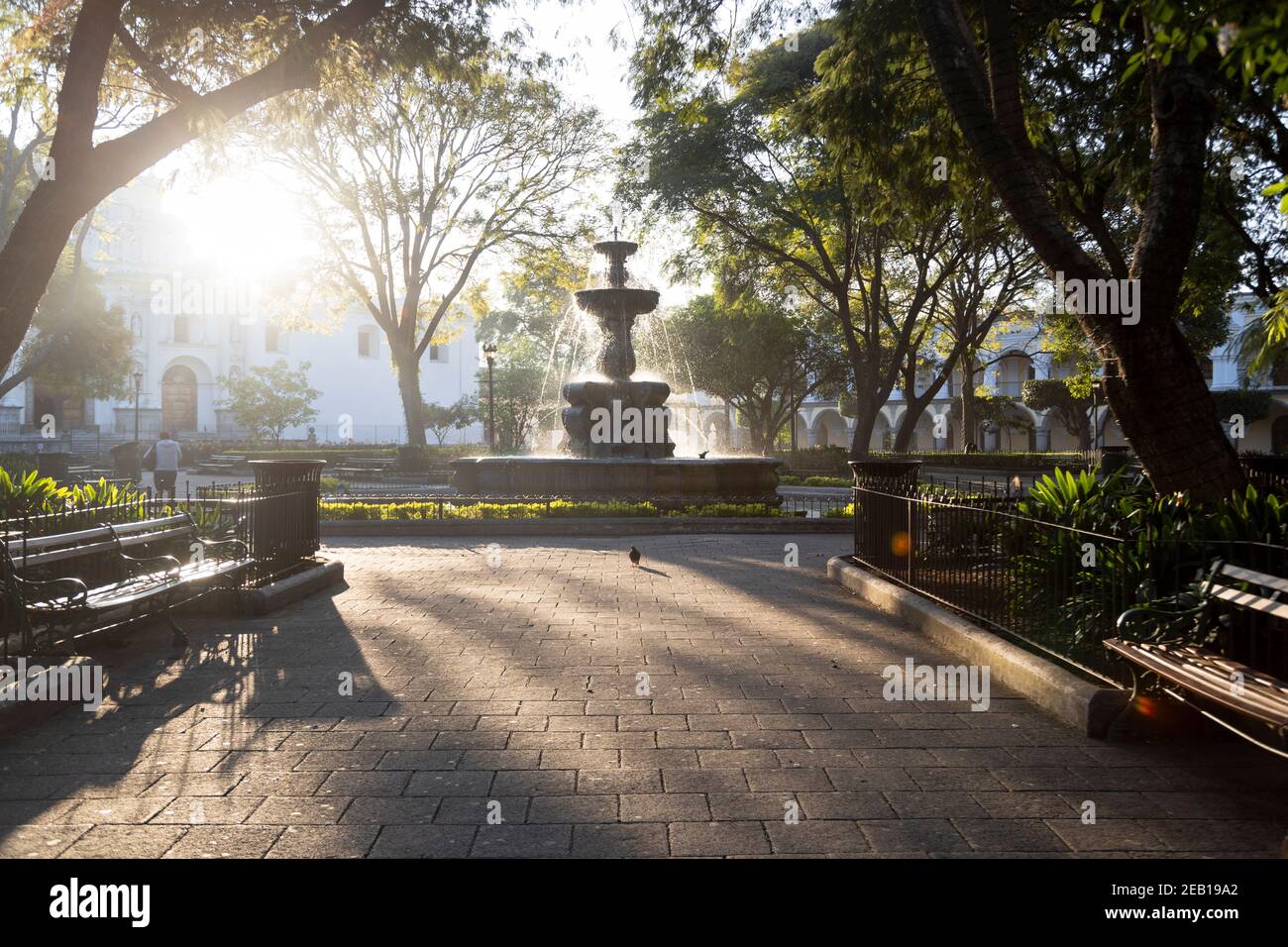 Central park of Antigua Guatemala at sunrise - Fountain of the Sirens in the middle of the park in colonial Guatemala City - Empty park early in the m Stock Photo