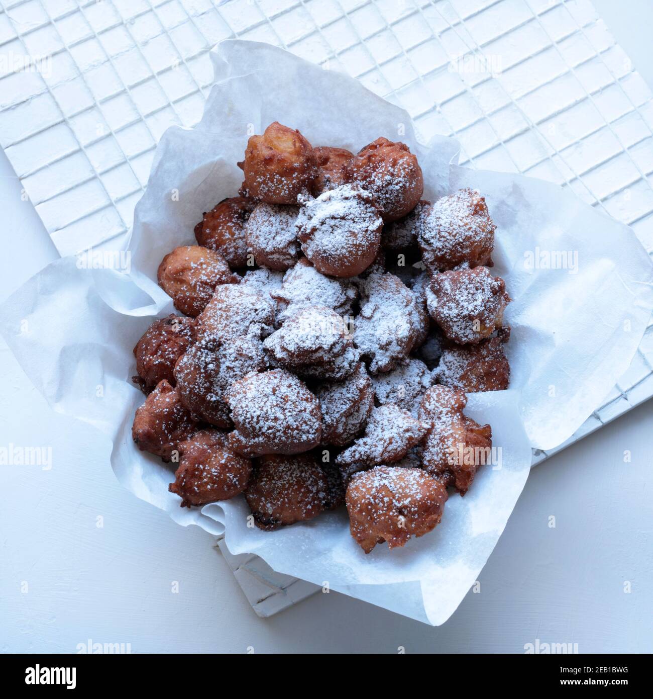 Italian food. Homemade traditional carnival sweets. Carnival fritters with sultanas on white background. Top view. Stock Photo