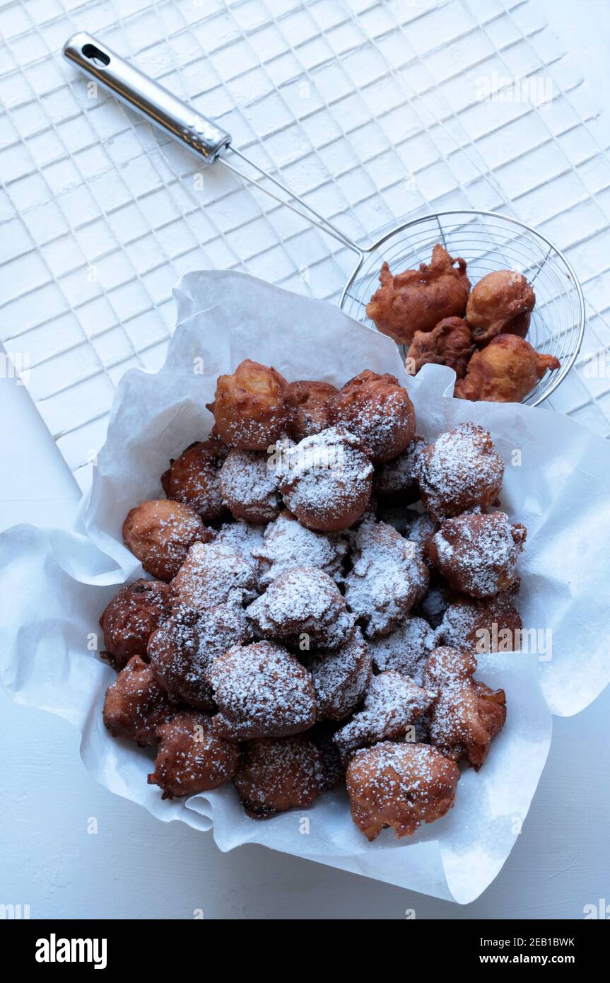 Italian food. Homemade traditional carnival sweets. Carnival fritters with sultanas on white background. Top view. Stock Photo