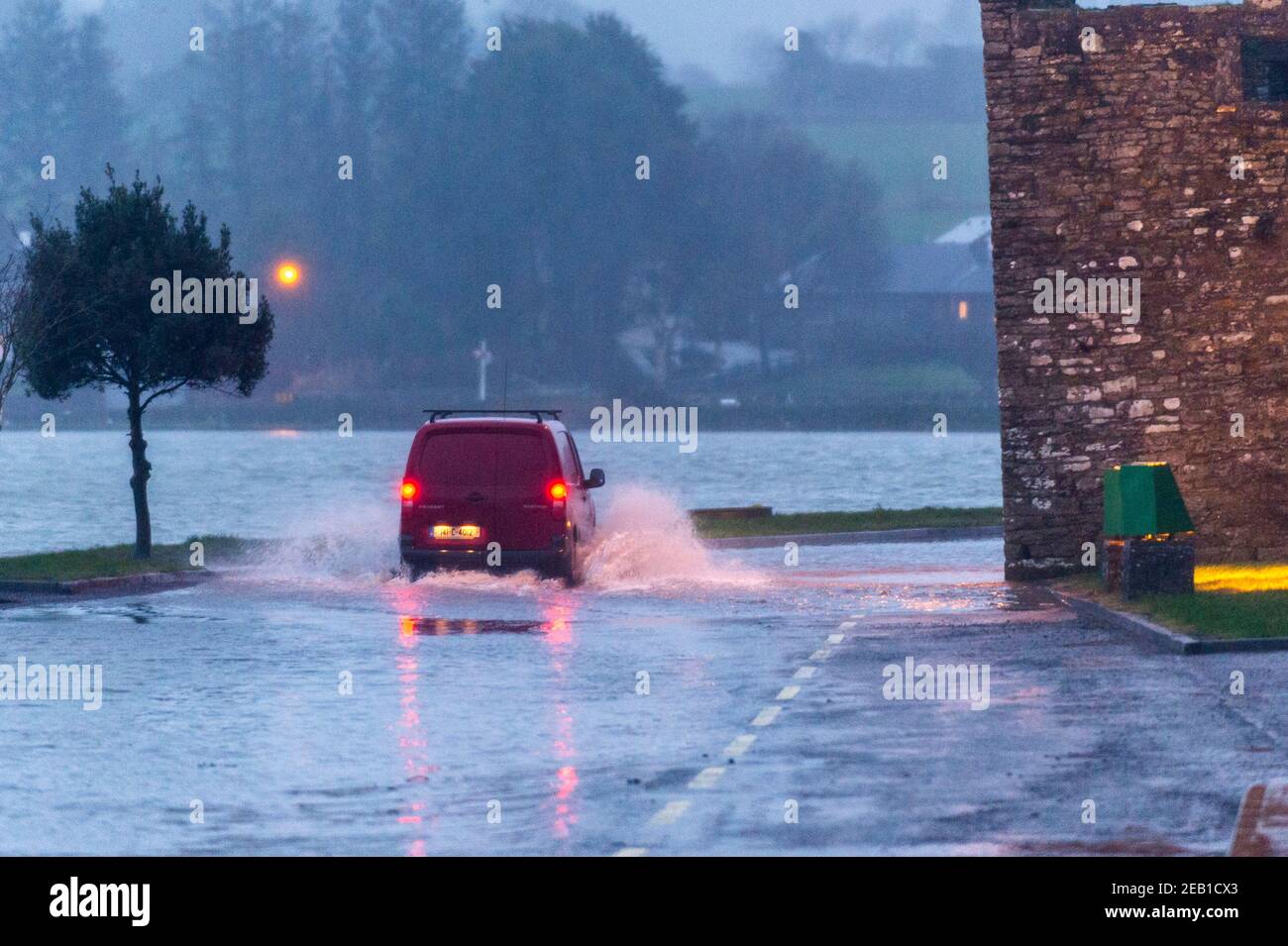 Timoleague, West Cork, Ireland. 11th Feb, 2021. After a day of torrential rain and winter showers, the road under Timoleague Abbey flooded at high tide this evening. Credit: AG News/Alamy Live News Stock Photo