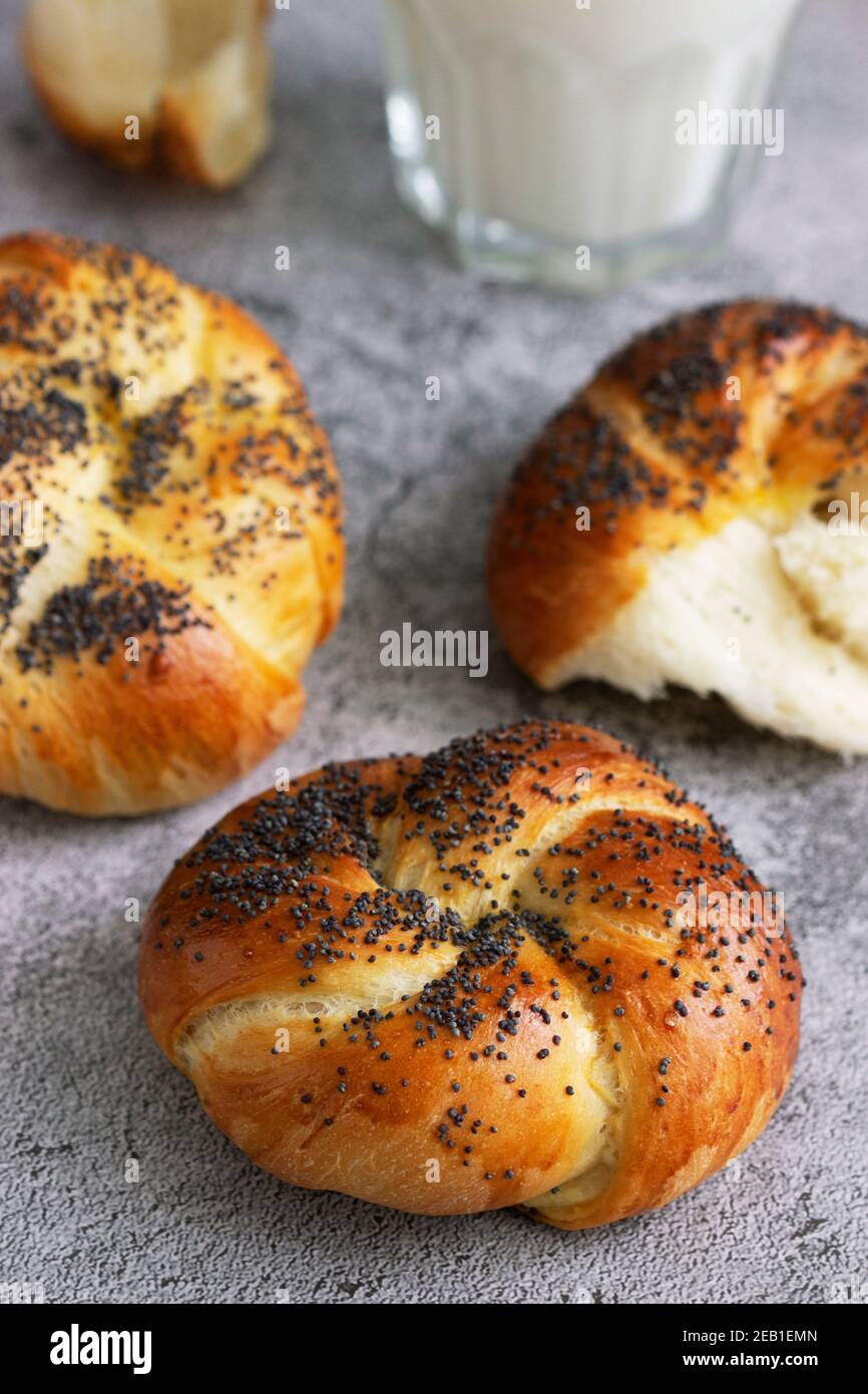 Sweet buns with poppy seeds served with milk. Stock Photo