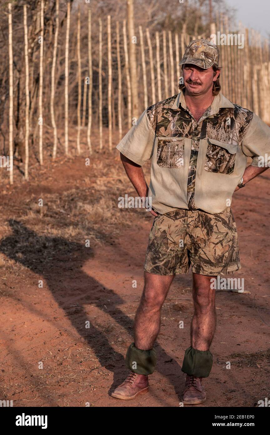 Protrait of wildlife ranch manager Berdus Henrico wearing camoflage on Oversprong farm, near Melkrivier, Limpopo Province, South Africa. Stock Photo