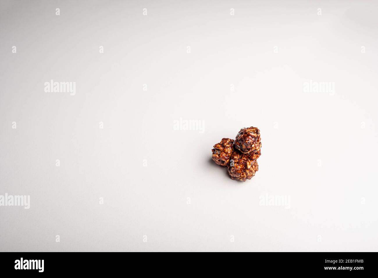 Chocolate popcorn on a white background. Stock Photo