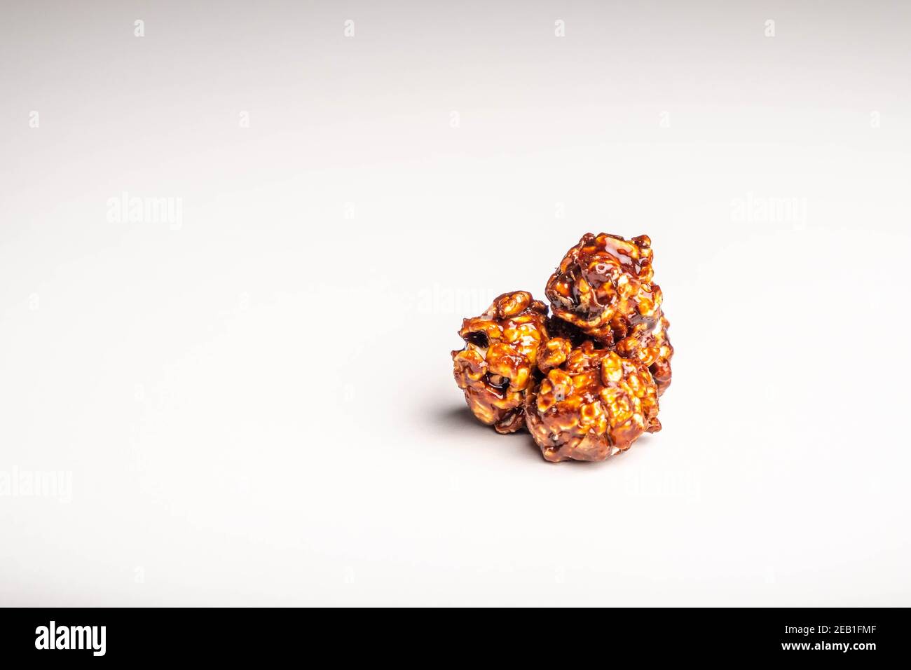 Chocolate popcorn on a white background. Stock Photo