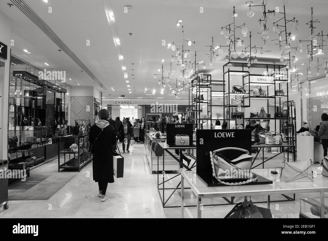 PARIS, FRANCE - JANUARY 27, 2018: People in shopping in Printemps department store. Loewe and Chanel boutiques. Black and white photo. Stock Photo