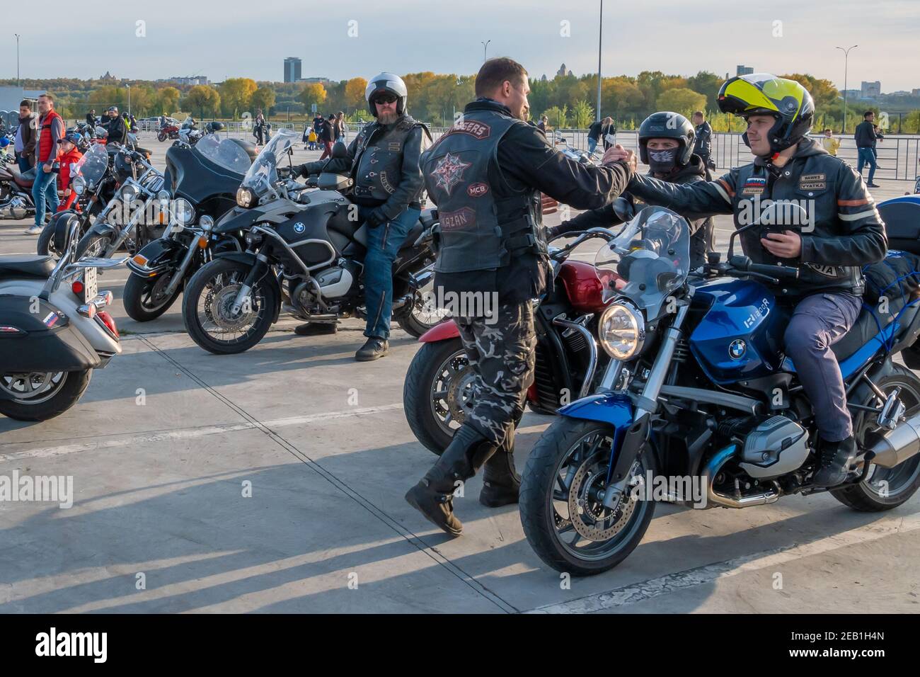 Kazan, Russia-September 26, 2020: One biker energetically greets another in the parking lot at a meeting for a biker ride together through the streets Stock Photo