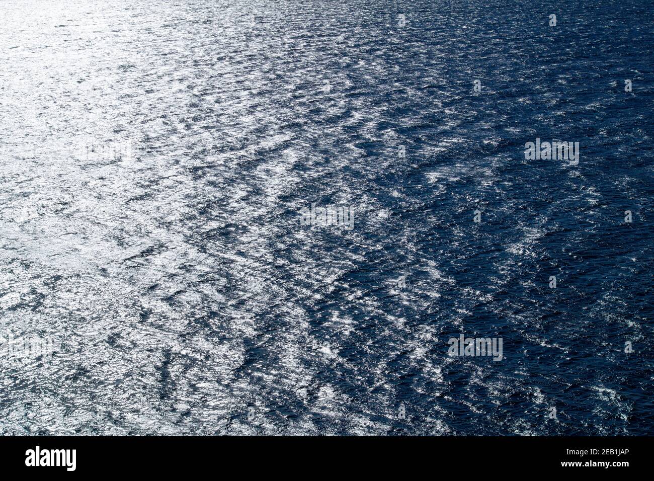 Photograph for background material of the wide sea surface that glitters in the sunlight Stock Photo