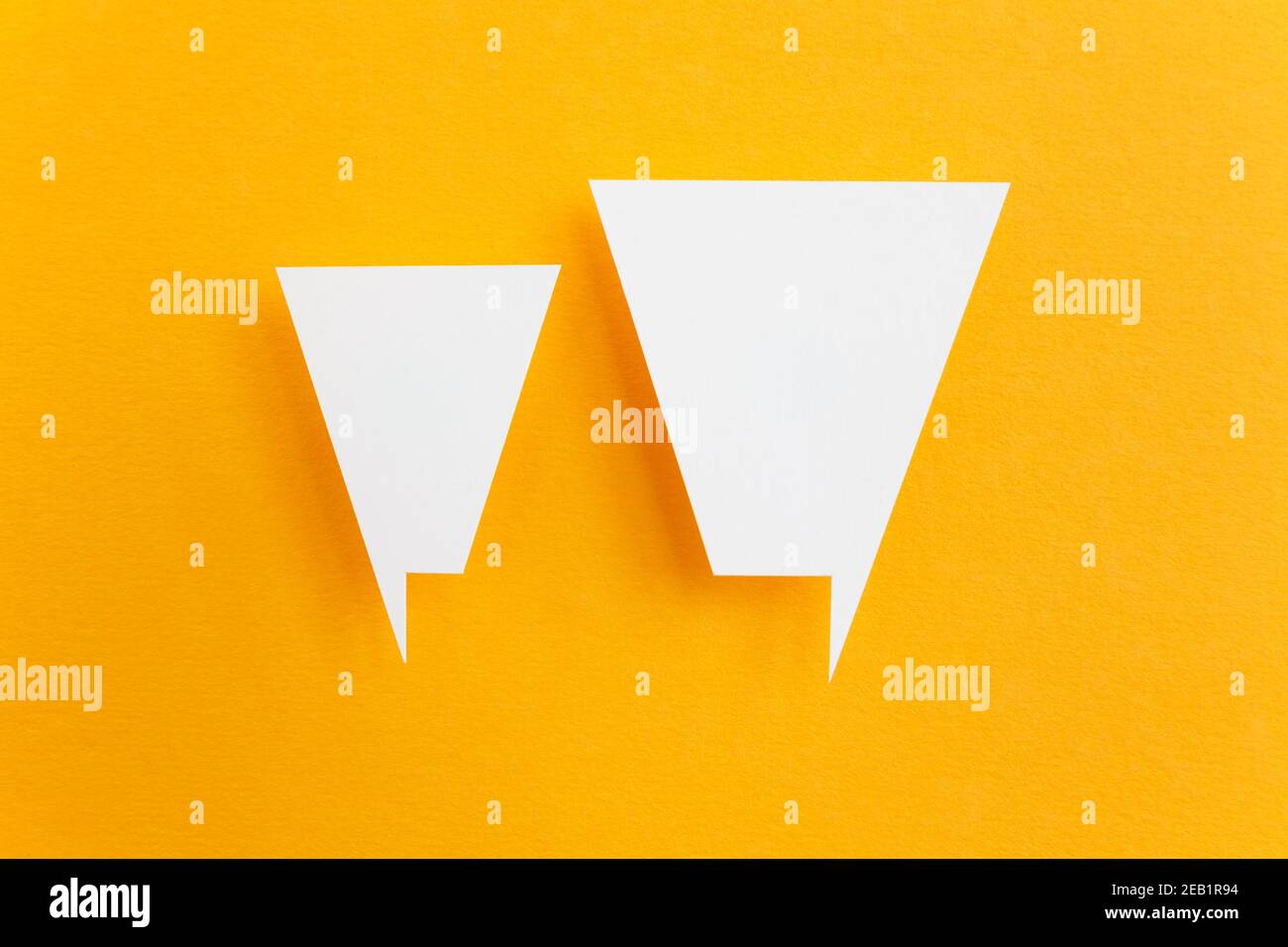 paper speech bubbles on yellow background Stock Photo - Alamy