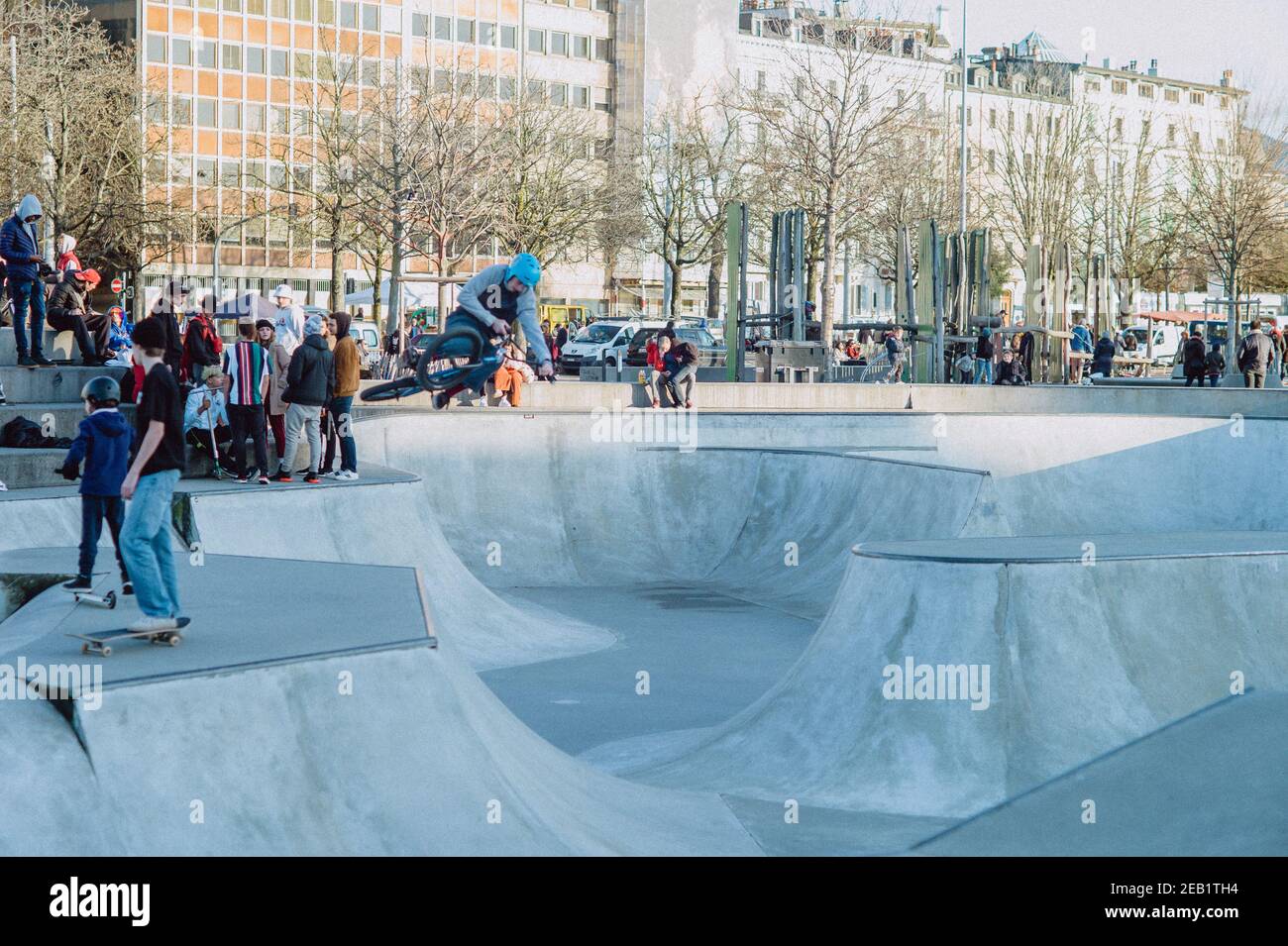 joung kids in a skate park with scooter or bikes Stock Photo - Alamy