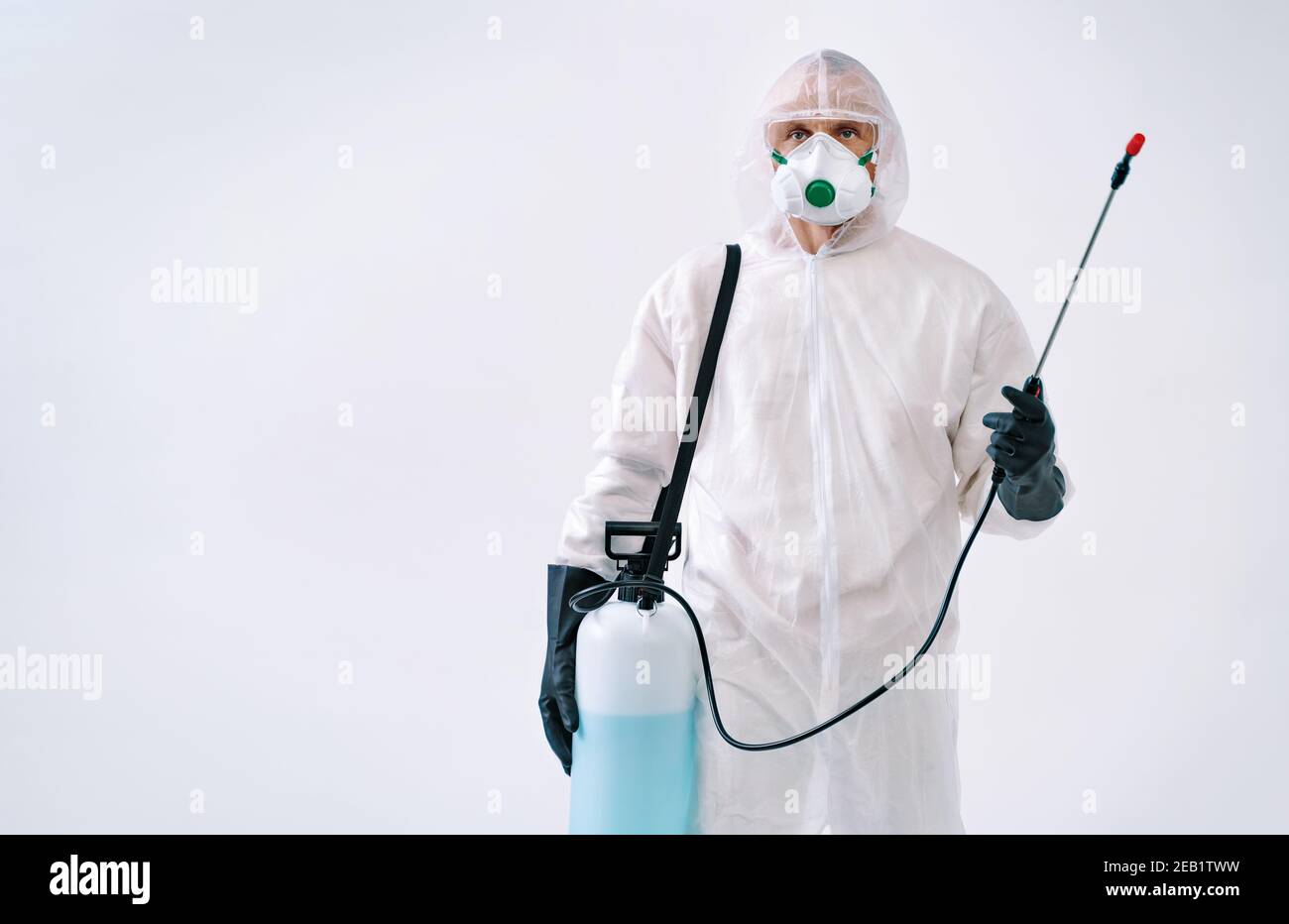 Disinfectant worker in protective suit making disinfection, to control an outbreak of virus Stock Photo