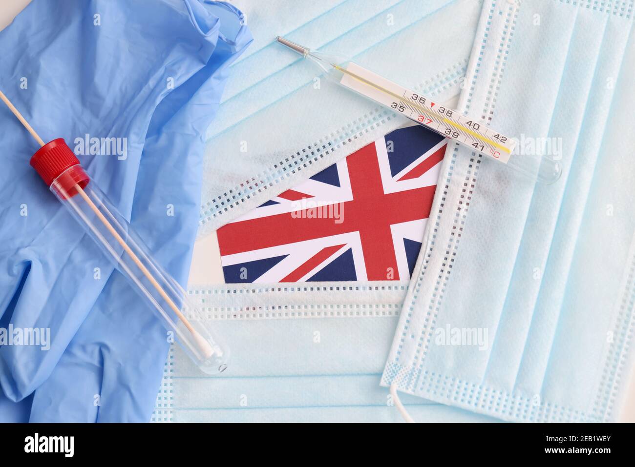 On table lies the British flag, medical protective masks and test for