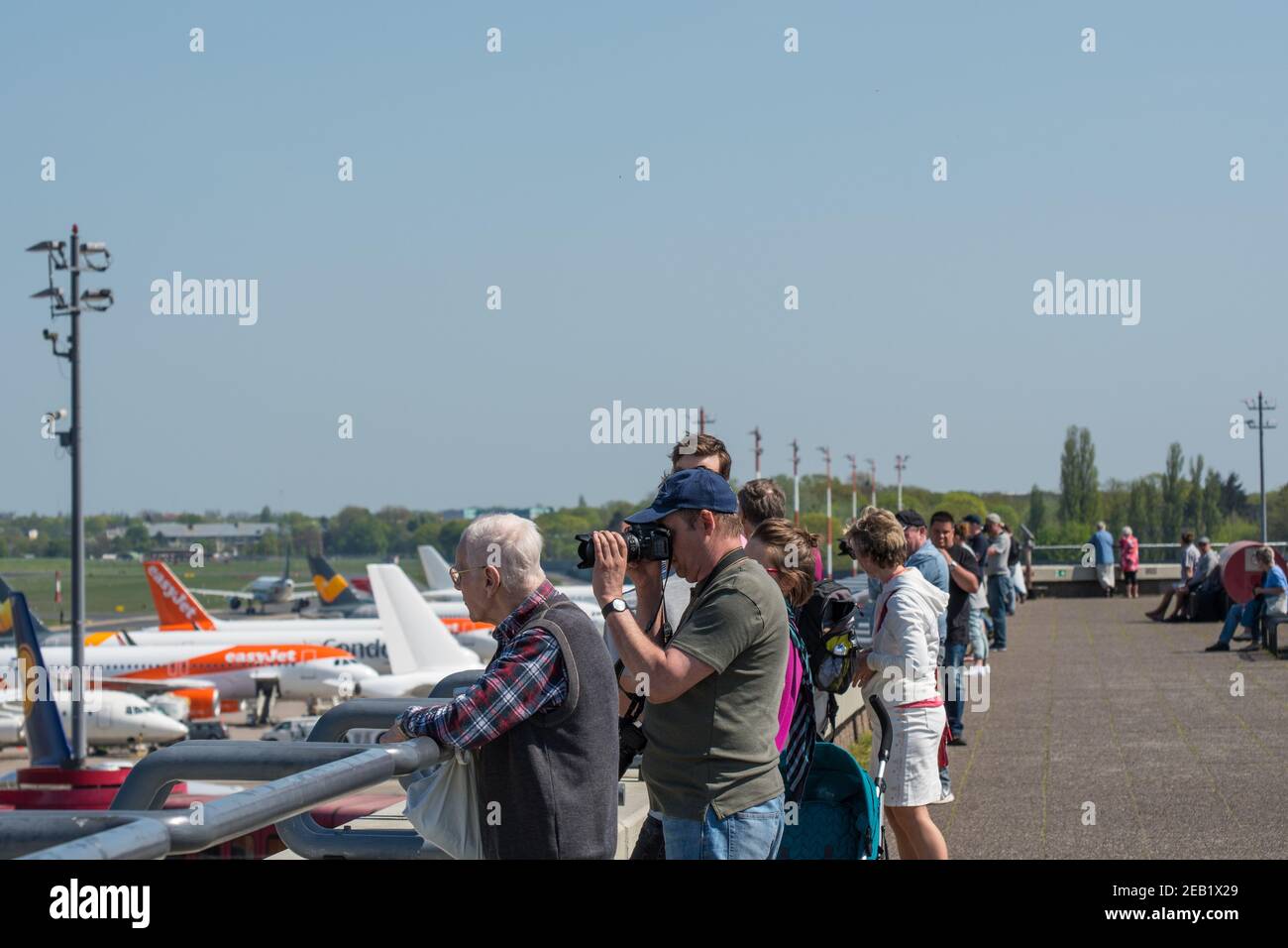 Berlin Germany - April 21. 2018: Berlin Germany - April 21. 2018: Airplane spotters looking at airplanes at the observations deck at Berlin Tegel airp Stock Photo