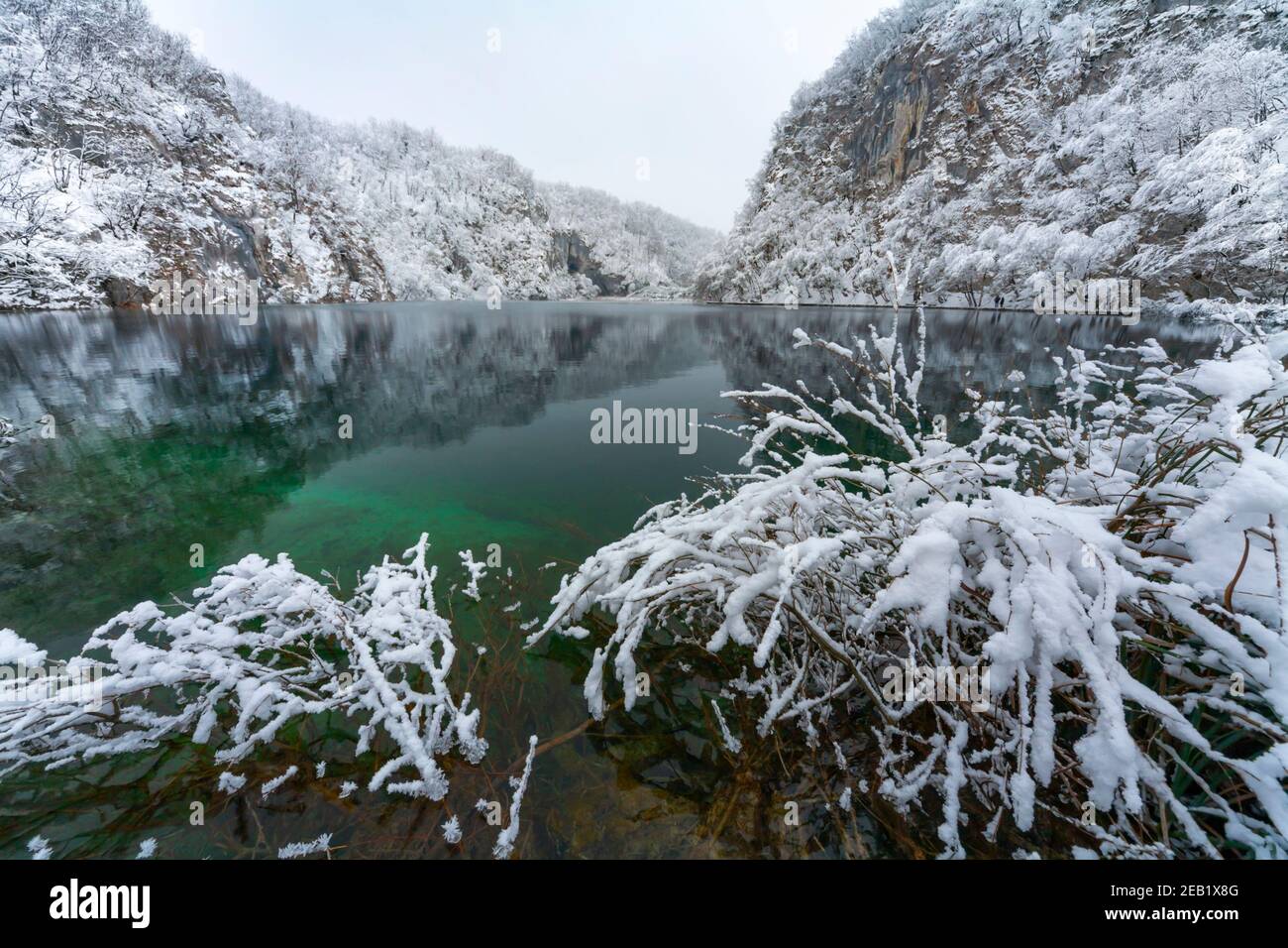 Quiet lake national park Plitvice lakes Croatia Europe Winter under covered cover snow ice calm water suface Stock Photo