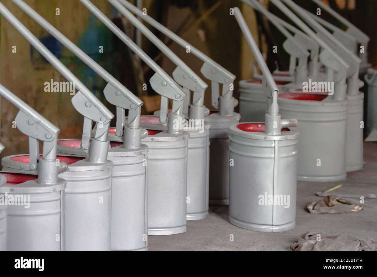 Gray-red hand pumps for pumping any liquid close-up. Industrial production Stock Photo