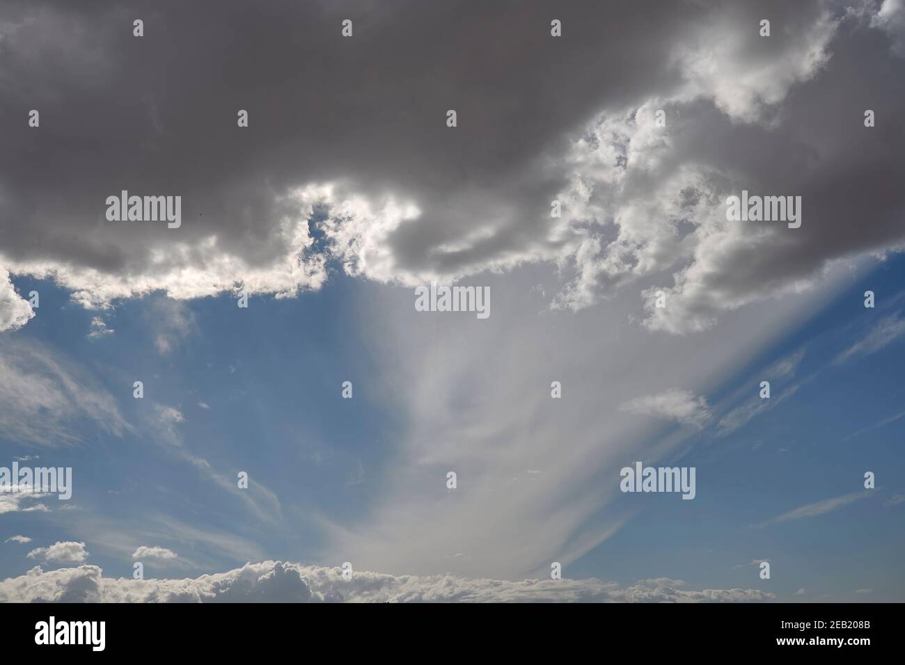 Sky full of dark white clouds. Horizontal white, blue and grey