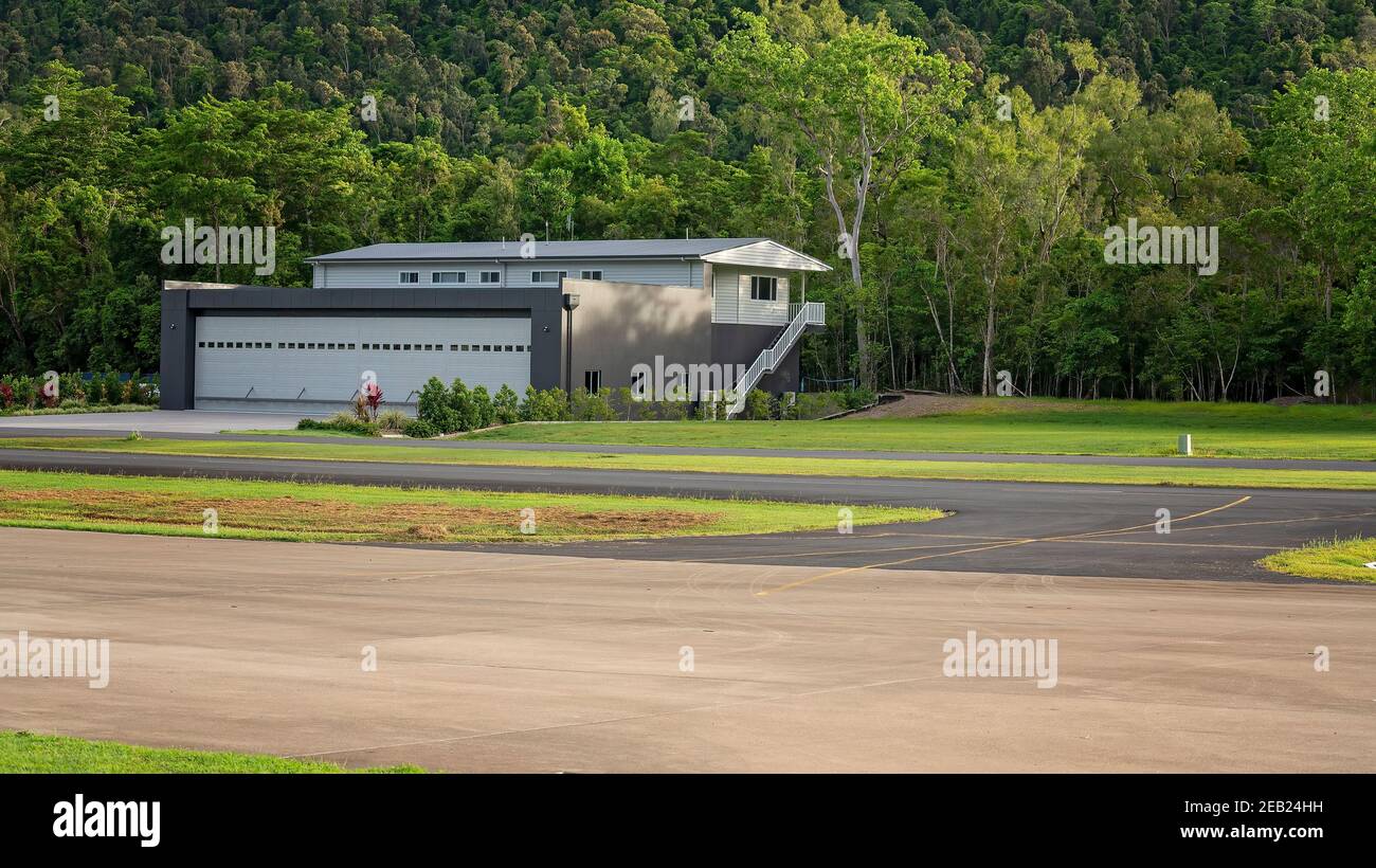 Airlie Beach, Queensland, Australia - February 2021: Caretakers house beside Whitsunday airport runway with storage for light aircraft Stock Photo